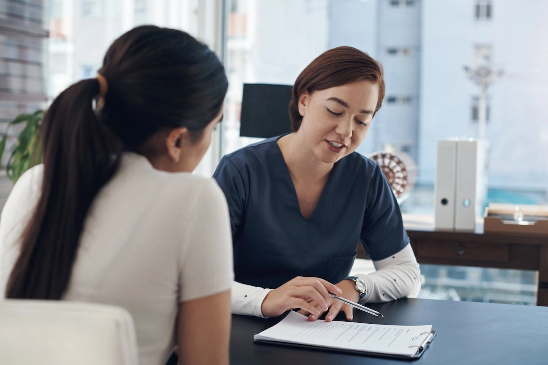 A clinician talks to a patient about insurance coverage for eating disorder treatment.